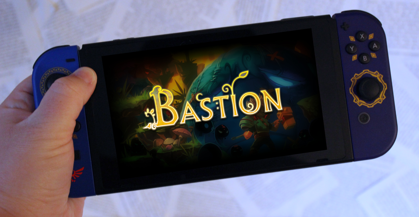 A hand holding a Nintendo Switch. The screen displays the splash image for the game Bastion