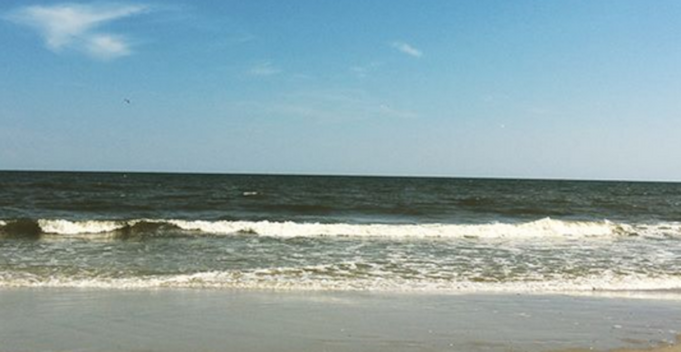 Waves crashing on a beach on a sunny day