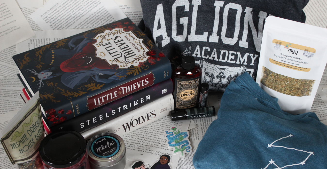 an image spread with a collection of books and other bookish items, including candles, tea, shirts, bath items, and stickers.